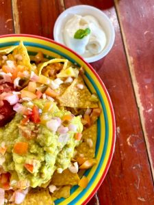 Plain Nachos, corn chips topped with cheese, pico de Gallo, salsa, guacamole & sour cream