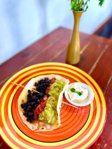 Soft Taco wit seaoned beef, steak, chicken, pork or grilled vegetables with cheese, black beanks, sour cream, guacamole and salsa of your choices 