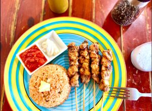 Spanish rice & grilled skewers ( Spanish rice served with either steak, chicken, pork or vegetables grilled skewers served with sour cream & salsa of your choices. 